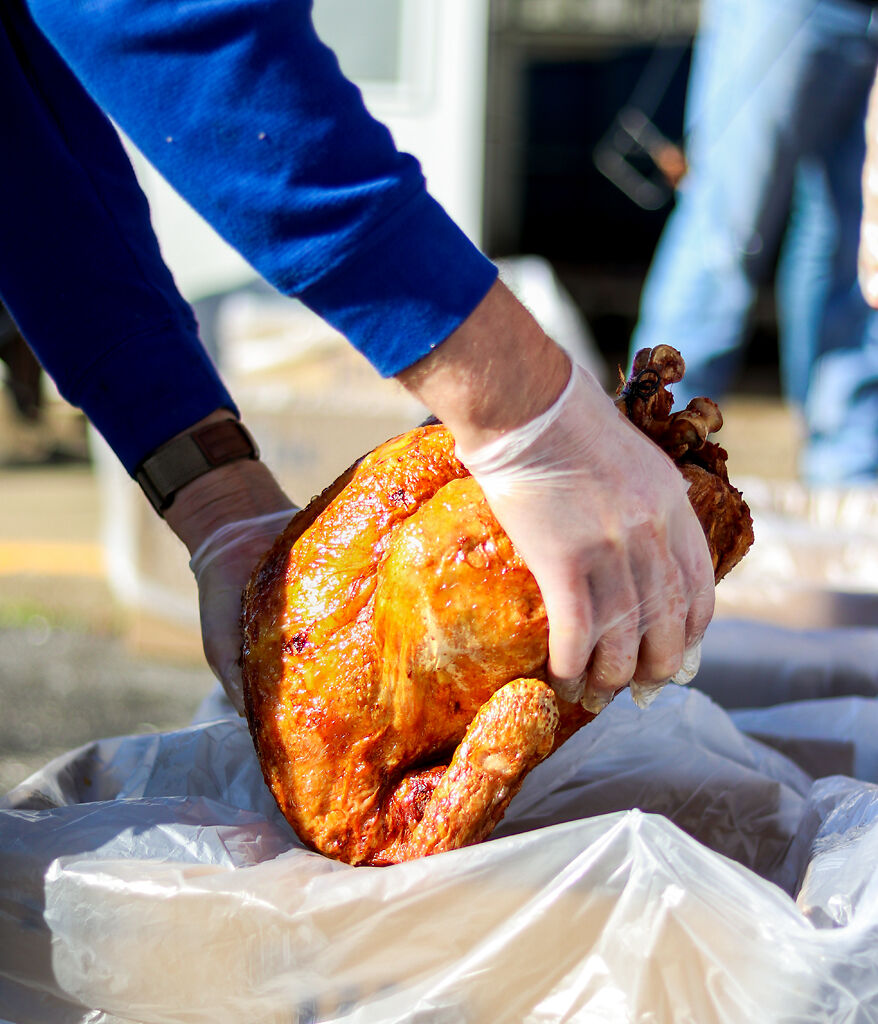 Mark Hargens places a turkey in a box